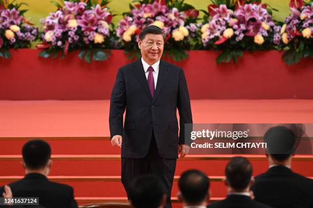 China's President Xi Jinping leaves the podium following his speech after a ceremony to inaugurate the city's new leader and government in Hong Kong...
