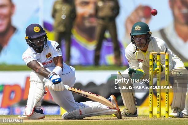 Sri Lanka's Pathum Nissanka plays a shot as Australia's wicketkeeper Alex Carey watches during the third day of play of the first cricket Test match...