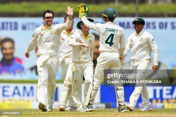 Australia's Travis Head celebrates with teammates after the dismissal of Sri Lanka's Dinesh Chandimal during the third day of first cricket Test...