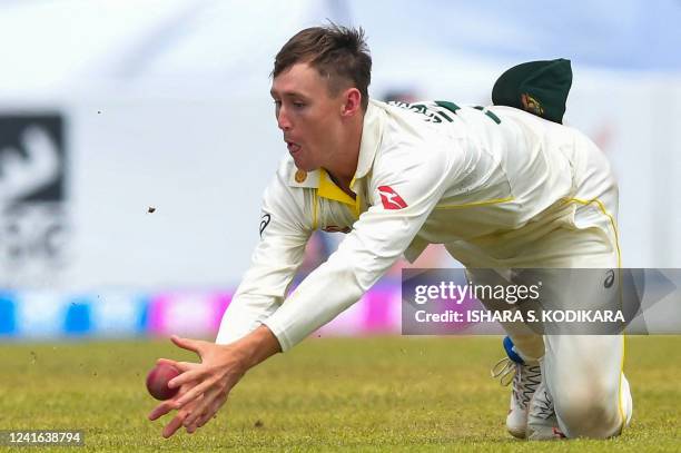 Australia's Marnus Labuschagne catches the ball to dismiss Sri Lanka's Niroshan Dickwella during the third day of first cricket Test match between...