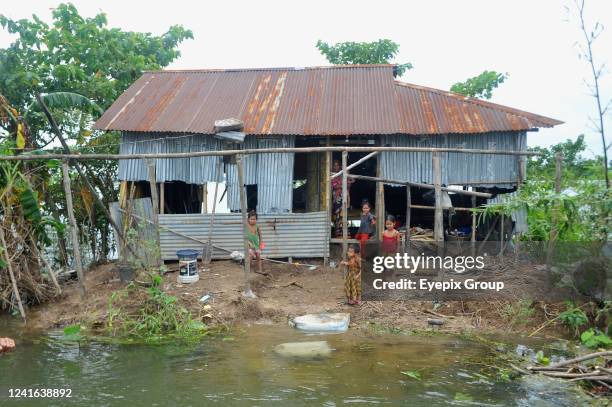 Residents of the Telikhal area of Companiganj Upazila come back to damaged homes in an area where flood victims need emergency assistance. On June...