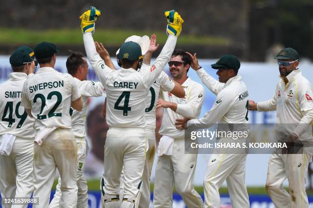 Australia's Travis Head celebrates with teammates after the dismissal of Sri Lanka's Lasith Embuldeniya during the third day of first cricket Test...