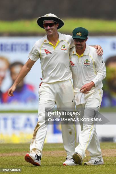 Australia's Travis Head and Captain Pat Cummins walk back to the pavilion at the end of second innings during the third day of first cricket Test...