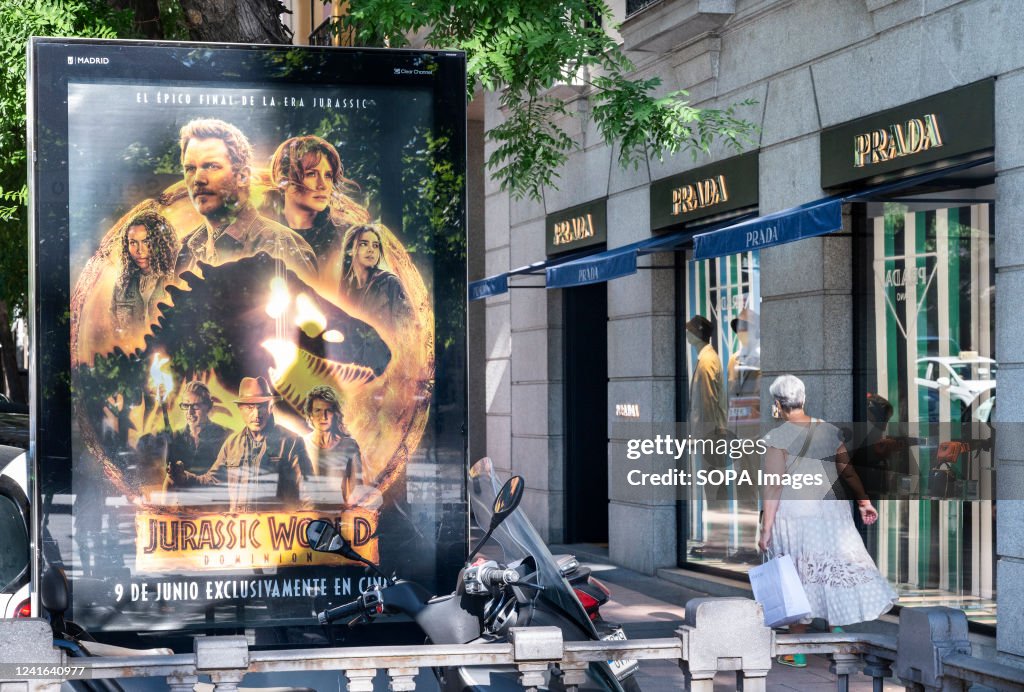 A pedestrian walks past a street commercial advertisement...