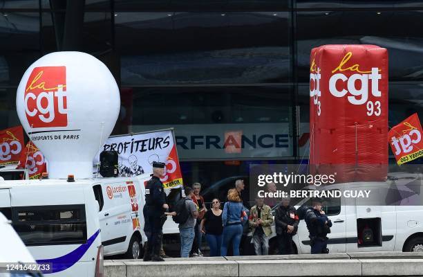 Paris Charles de Gaulle airport employees gather outside a terminal as they stage a strike at Roissy Charles De Gaulle Airport, north of Paris, on...