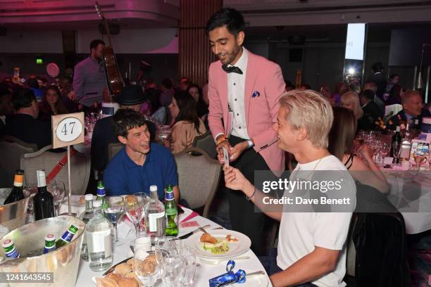 Dan Rothman and Dot Major of London Grammer participate in a magic trick at the Nordoff Robbins O2 Silver Clef Awards at The Grosvenor House Hotel on...