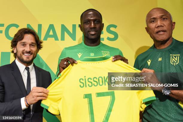French midfielder Moussa Sissoko receives Nantes jersey during his presentation to the press with French FC Nantes CEO Franck Kita and Nantes' French...