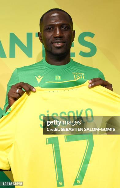 French midfielder Moussa Sissoko receives Nantes jersey during his presentation to the press at La Joneliere training centre in La...