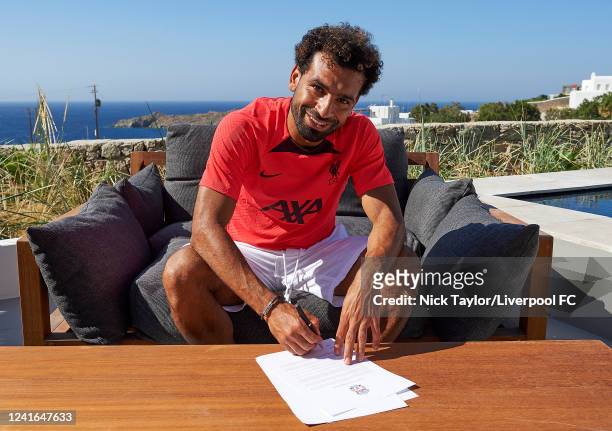 Mohamed Salah of Liverpool signs a contract extension while on holiday on June 19, 2022 in Mykonos, Greece.