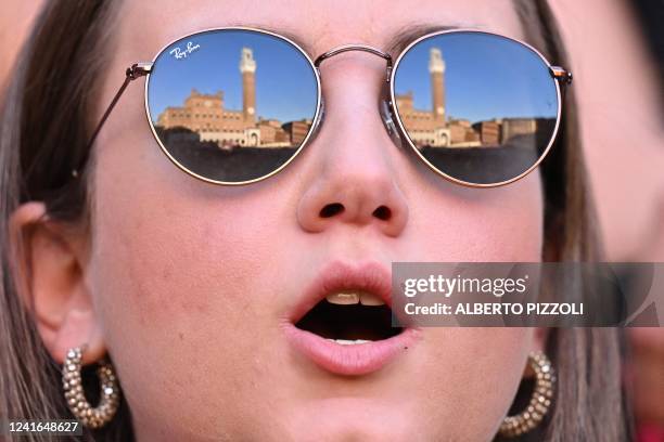 Supporter of the "Istrice" contrada reacts as people gather at Piazza del Campo for a rehearsal, on the eve of the historical Italian horse race...
