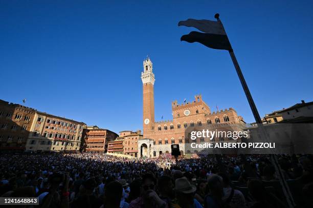 People gather on piazza del Campo to watch a rehearsal on the eve of the historical Italian horse race "Palio di Siena" on July 1, 2022 in Siena,...