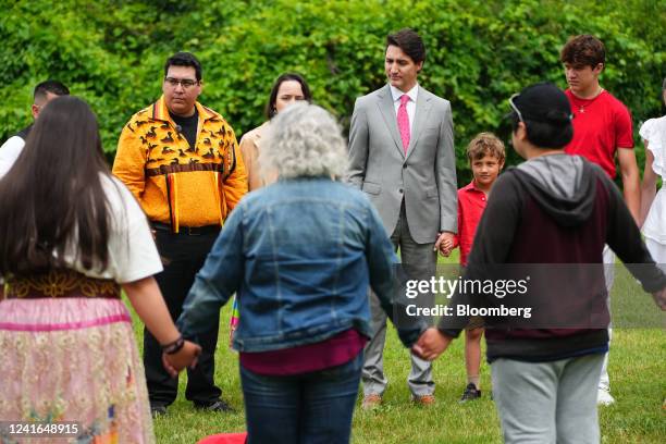 Prime Minister Justin Trudeau, left, and family members attend an Indigenous Reflection Ceremony near the banks of the Ottawa River on Canada Day in...