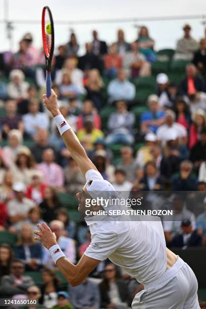 Player John Isner serves to Italy's Jannik Sinner during their men's singles tennis match on the fifth day of the 2022 Wimbledon Championships at The...