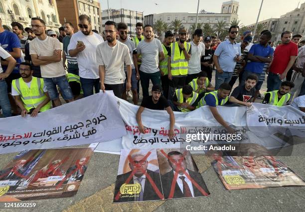 Young people stage a protest demanding the dissolution of the legislative and executive institutions in the country at Martyr's Square in Tripoli,...