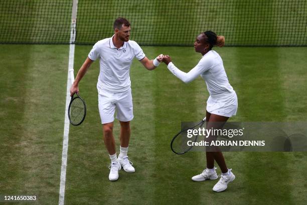 Player Venus Williams and Britain's Jamie Murray speak together during their mixed doubles tennis match against New Zealand's Michael Venus and...