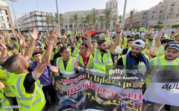 Young people stage a protest demanding the dissolution of the legislative and executive institutions in the country at Martyr's Square in Tripoli,...