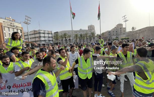 Young people stage a protest demanding the dissolution of the legislative and executive institutions in the country at Martyr's Square in Tripoli,...