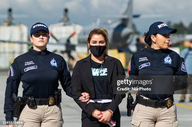 Nini Johana Usuga alias 'La Negra', sister of Colombian drug lord Dairo Antonio Usuga, alias 'Otoniel', is escorted by Interpol police officers...