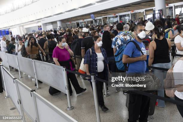 Travelers at John F. Kennedy International Airport in the Queens borough of New York, US, on Friday, July 1, 2022. As travel is ramping up for the...