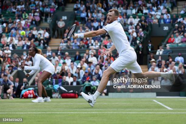 Britain's Jamie Murray , playing with US player Venus Williams , returns the ball to New Zealand's Michael Venus and Poland's Alicja Rosolska during...