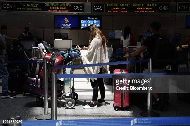 Traveler waits for a Singapore Airlines flight inside Tom Bradley International Terminal at Los Angeles International Airport in Los Angeles,...