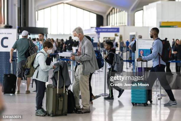 Travelers line up to check in for United Airlines flights at Newark Liberty International Airport on July 1, 2022 in Newark, New Jersey. Hundreds of...