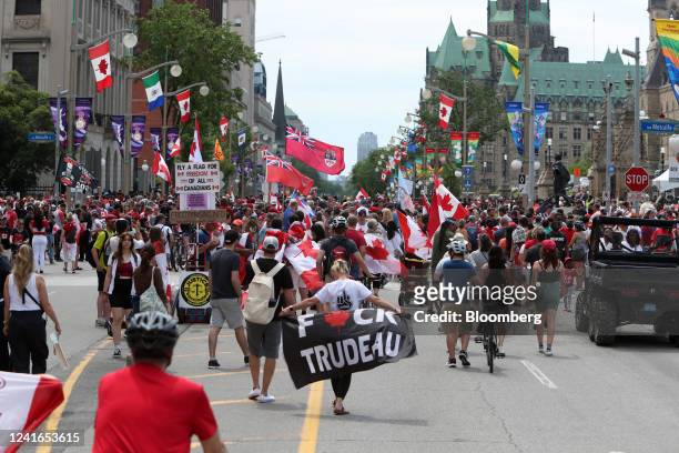 Image contains profanity) Revelers and demonstrators along Wellington Street near Parliament Hill on Canada Day in Ottawa, Ontario, Canada, on...