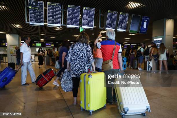 Passengers are seen at the Barajas Airport in Madrid on July 1, 2022.