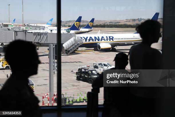 Ryanair planes and passengers in the terminal are seen at the Barajas Airport in Madrid on July 1, 2022.