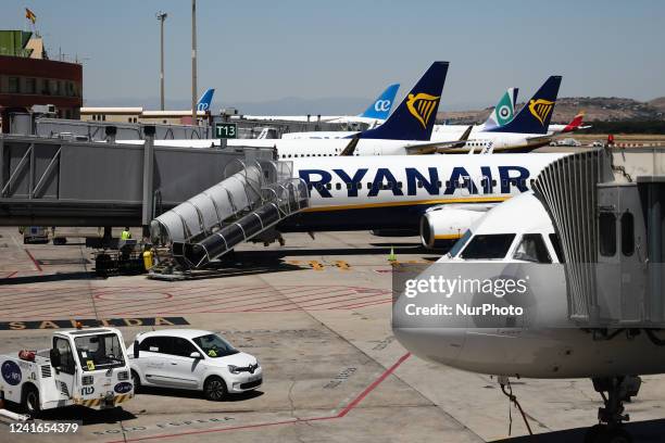 Planes and airport vehicles are seen at the Barajas Airport in Madrid on July 1, 2022.