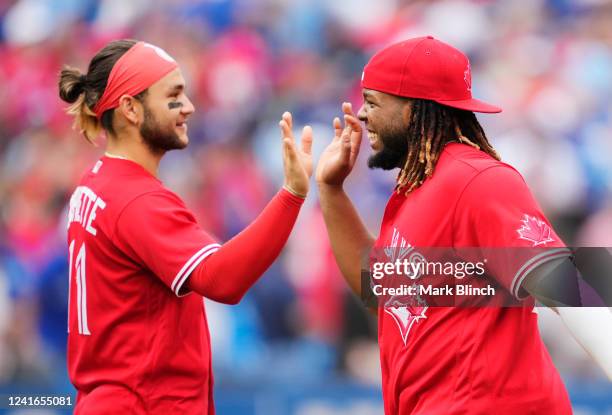 Vladimir Guerrero Jr. #27 and Bo Bichette of the Toronto Blue Jays celebrate defeating the Tampa Bay Rays in their MLB game at the Rogers Centre on...