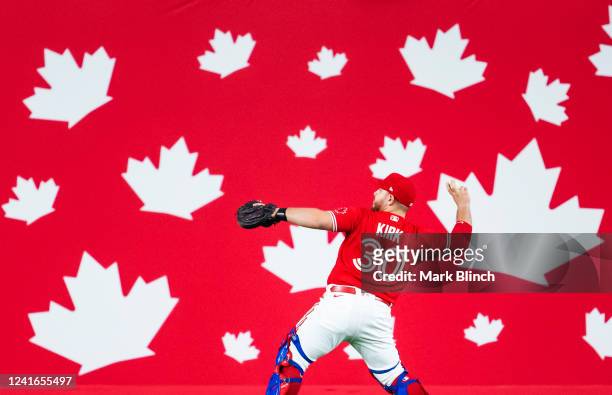 Alejandro Kirk of the Toronto Blue Jays warms up in front of Canada Day decorations before playing the Tampa Bay Rays in their MLB game at the Rogers...