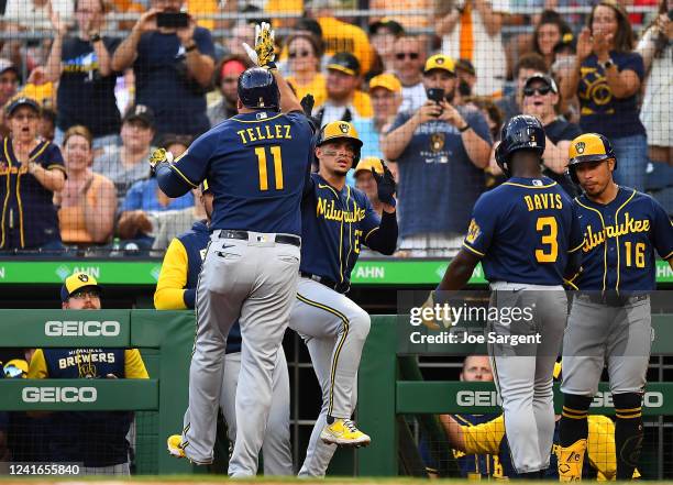 Rowdy Tellez celebrates his three run home run with Willy Adames of the Milwaukee Brewers during the second inning against the Pittsburgh Pirates at...