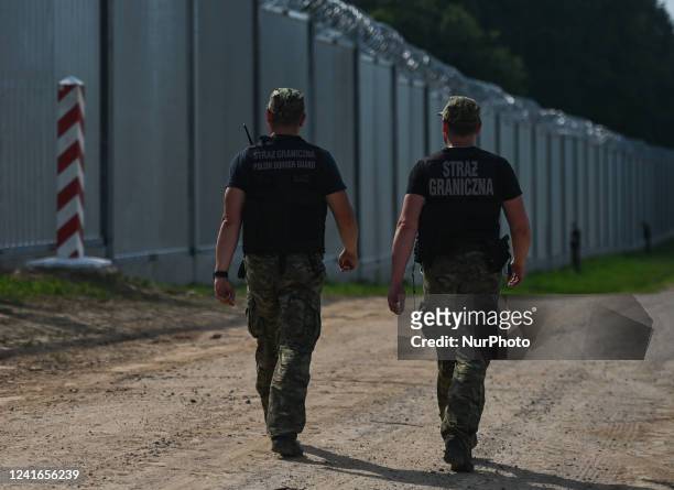 Polish border guards near the new fence on the Polish-Belarusian border near the village of Nowdziel. Prime Minister Mateusz Morawiecki appeared on...