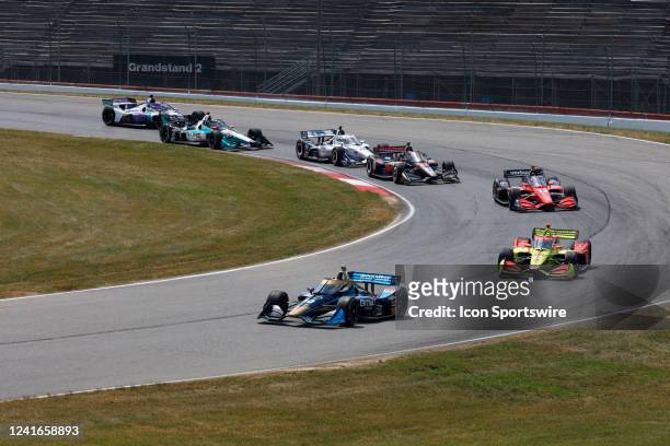 IndyCar driver Conor Daly leads a pack of cars through turn 4 at Mid Ohio on July 1, 2022 in Lexington, Ohio.