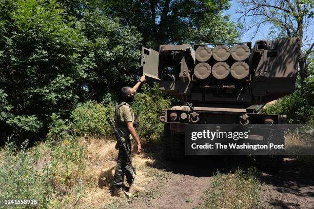 Kuzia, the commander of the unit, shows the rockets on HIMARS vehicle in Eastern Ukraine on July 1, 2022.