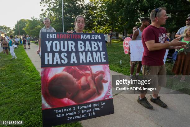 Demonstrator holds a placard during a counter protest against an abortion rights rally in Memorial Park. About 50 anti-abortion rights demonstrators...