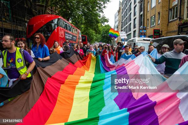 Campaigners with a large inclusive Pride flag join Gay Liberation Front veterans marking the 50th anniversary of the first UK Pride march in 1972 by...