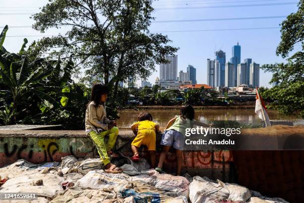 Children play near their houses in a slum in Jakarta, Indonesia on June 29, 2022. The pandemic is forcing more people to live in poverty, The Central...