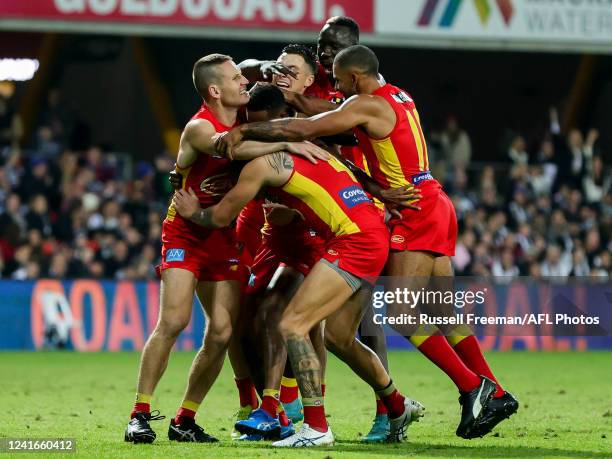 Hewago Paul Oea of the Suns celebrates a goal during the 2022 AFL Round 16 match between the Gold Coast Suns and the Collingwood Magpies at Metricon...