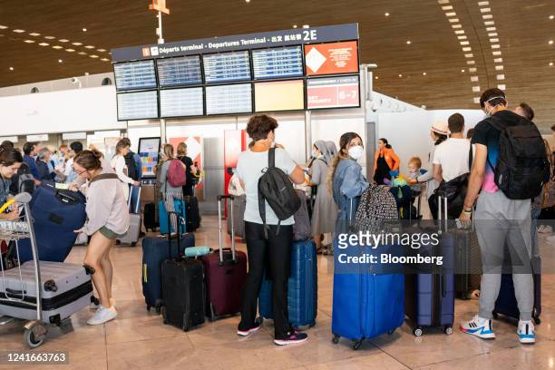 Queues of passengers in the departure hall during a strike by airport workers at Charles de Gaulle airport in Paris, France, on Saturday, July 2,...