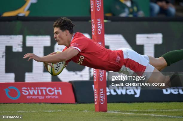 Wales' wing Louis Rees-Zammit dives to score the team's first try during an international rugby union match between South Africa and Wales at Loftus...