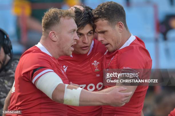 Wales' wing Louis Rees-Zammit celebrates with teammates after scoring the team's first try during an international rugby union match between South...