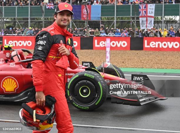 Ferrari's Spanish driver Carlos Sainz Jr, who finished fastest to take pole position, reacts after the third and final qualifying session for the...