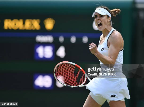 France's Alize Cornet reacts as she competes against Poland's Iga Swiatek during their women's singles tennis match on the sixth day of the 2022...