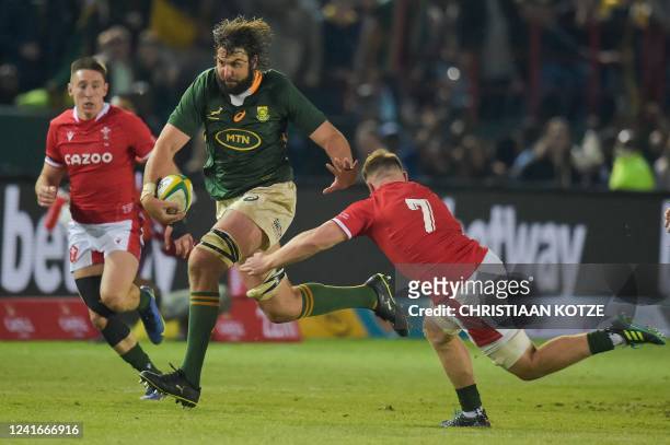 South Africa's lock Lood de Jager runs with the ball as Wales' flanker Tommy Reffell prepares to tackle him during an international rugby union match...