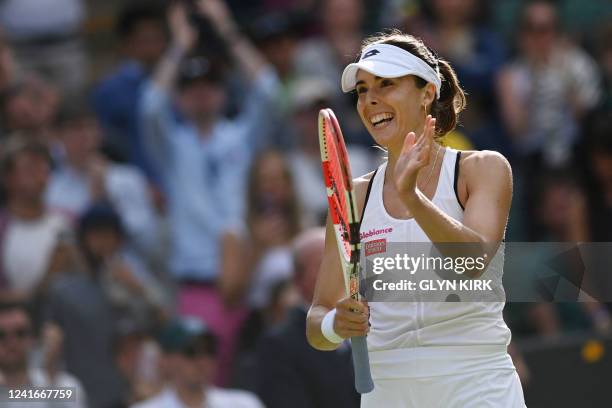 France's Alize Cornet celebrates beating Poland's Iga Swiatek during their women's singles tennis match on the sixth day of the 2022 Wimbledon...