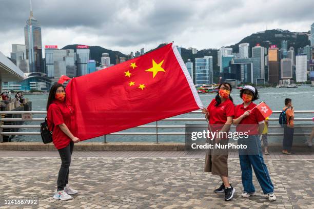 Pro-China militants deploy a Chinese flag in Tsim Sha Tsui on the 25th anniversary of the retrocession of Hong Kong to China, in Hong Kong, China, on...