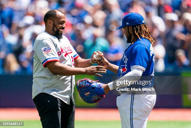 KTORONTO, ON Vladimir Guerrero Jr. #27 of the Toronto Blue Jays gives a ball to his father a former baseball player Vladimir Guerrero, after his...