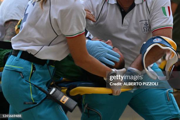 Medics evacuate Italian jockey Stefano Piras, who races for the "Bruco" district, after he fell during a false start of his horse "Uragano Rosso"...